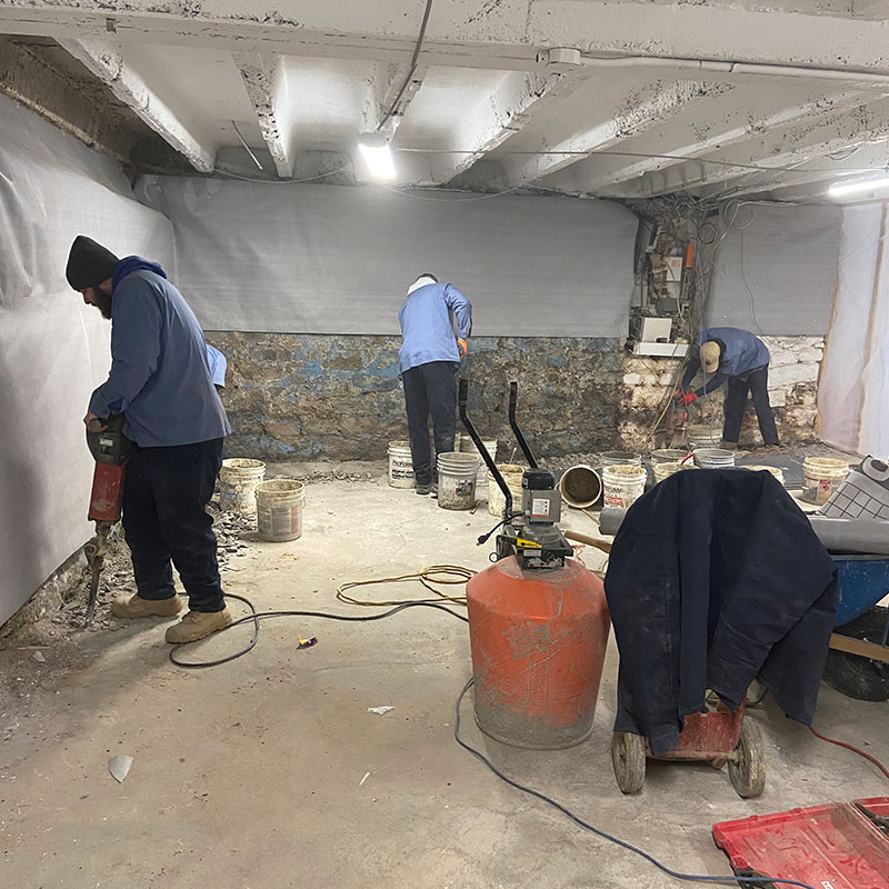 ARK team repairing water in basement to avoid black mold