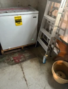 Interior French drain installation and sump pump system in a basement in Erie, PA