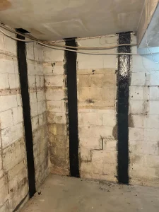 Rhino Carbon Fiber Straps installed on a bowing foundation wall in Bethel Park, PA to reinforce the garage foundation and prevent further structural movement.