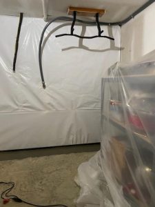 Waterproofing basement walls with a protective wall liner and interior perimeter drainage system